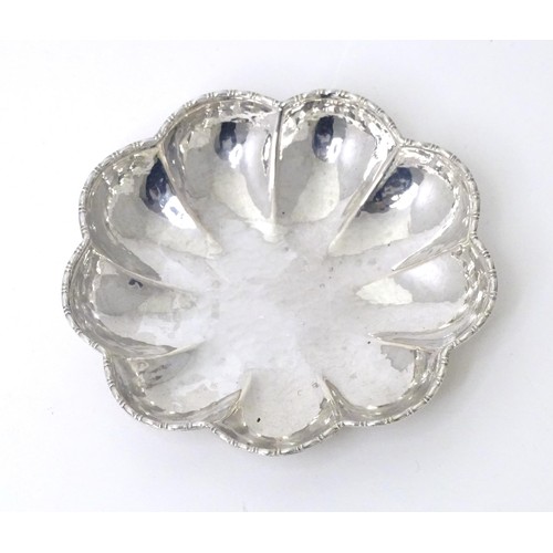 460 - A Continental .800 silver dish of lobed form with hammered decoration. Approx. 3 1/2