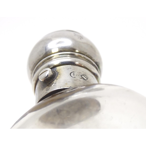 465 - A glass perfume / scent bottle with white metal top. Approx. 3