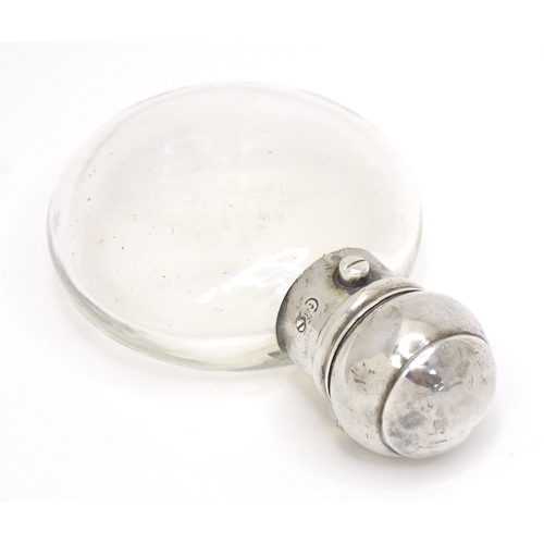 465 - A glass perfume / scent bottle with white metal top. Approx. 3