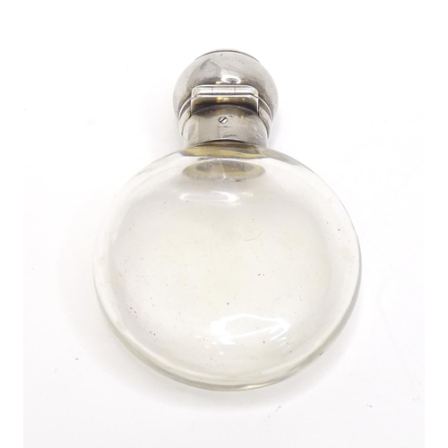 465 - A glass perfume / scent bottle with white metal top. Approx. 3