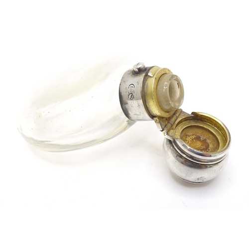 465 - A glass perfume / scent bottle with white metal top. Approx. 3