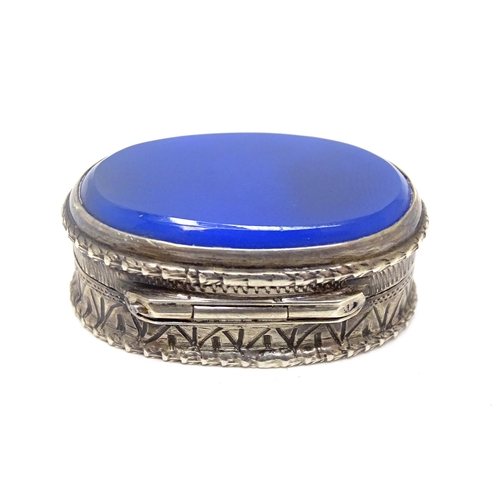 483 - A Continental .800 silver pill box with inset blue detail to top. Approx. 1 1/4