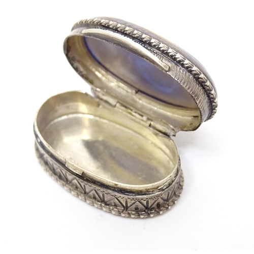 483 - A Continental .800 silver pill box with inset blue detail to top. Approx. 1 1/4