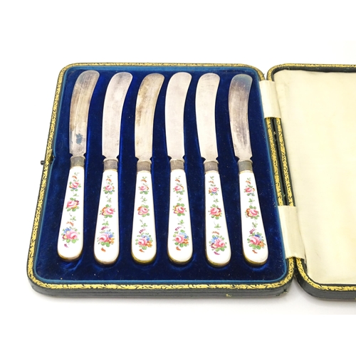 518 - A set of six tea knives with silver collars and gilt and floral decorated ceramic handles, the colla... 