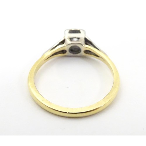 574 - An 18ct gold diamond solitaire ring in a square setting. Ring size approx O