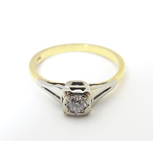 574 - An 18ct gold diamond solitaire ring in a square setting. Ring size approx O