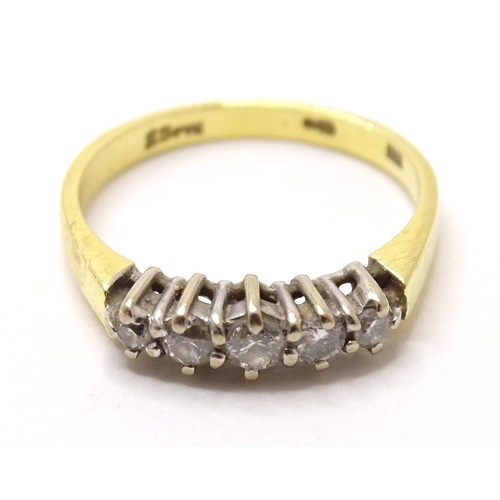 576 - An 18ct gold ring set with 5 diamonds. ring size approx. I