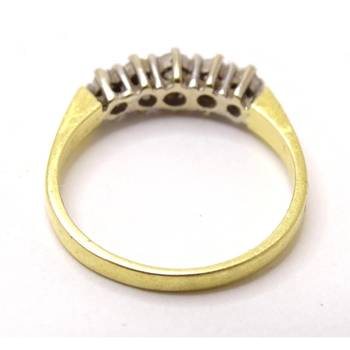 576 - An 18ct gold ring set with 5 diamonds. ring size approx. I