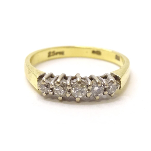 576 - An 18ct gold ring set with 5 diamonds. ring size approx. I