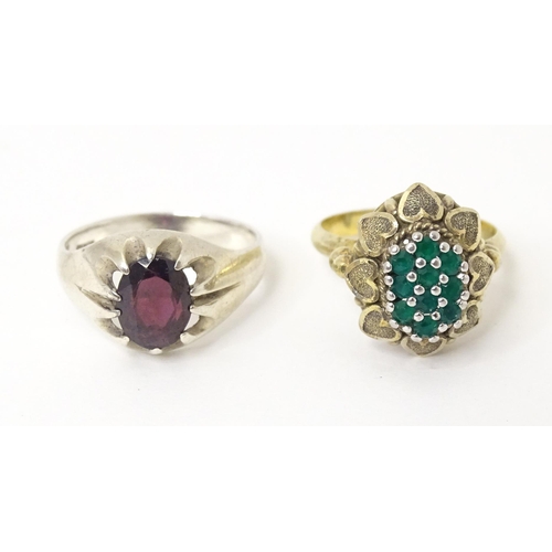 606 - A silver ring set with purple stone (Ring size approx. Q) Together with a silver gilt ring set with ... 