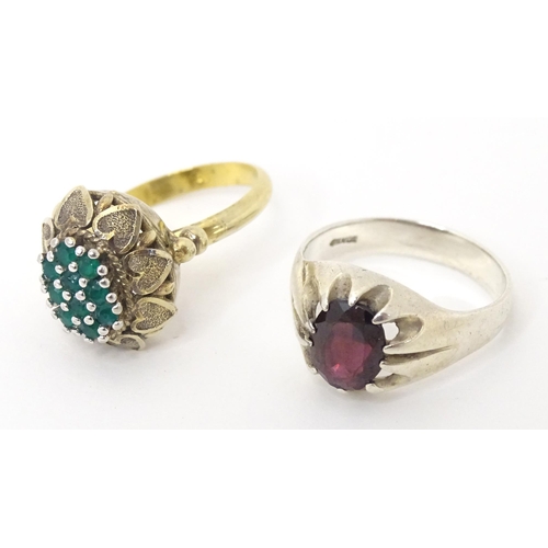 606 - A silver ring set with purple stone (Ring size approx. Q) Together with a silver gilt ring set with ... 