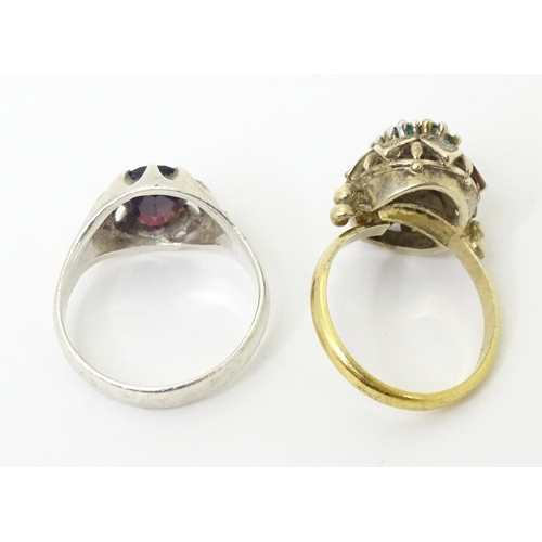 606 - A silver ring set with purple stone (Ring size approx. Q) Together with a silver gilt ring set with ... 