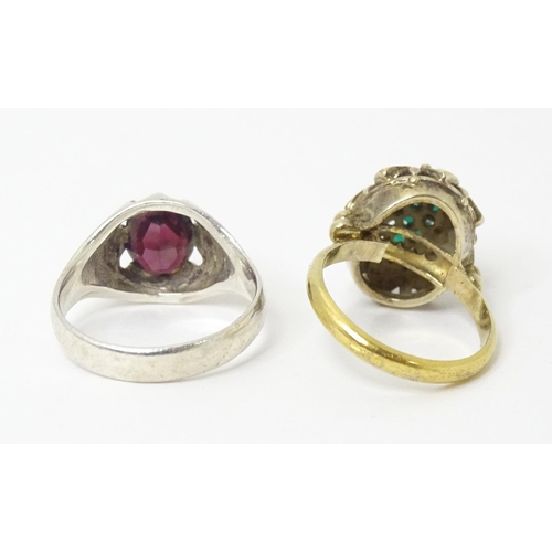 606 - A silver ring set with purple stone (Ring size approx. Q) Together with a silver gilt ring set with ... 