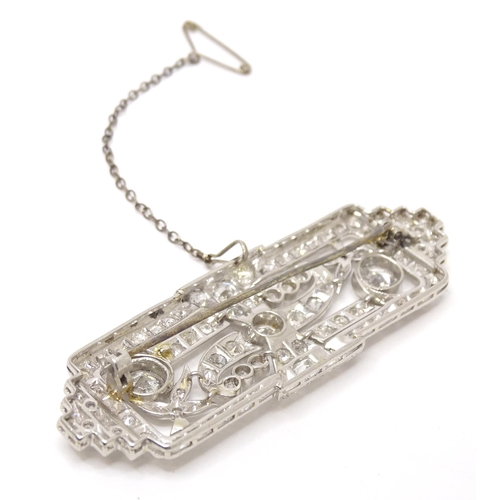 661 - An impressive Art Deco white metal brooch set with a profusion of diamonds. The two largest diamonds... 