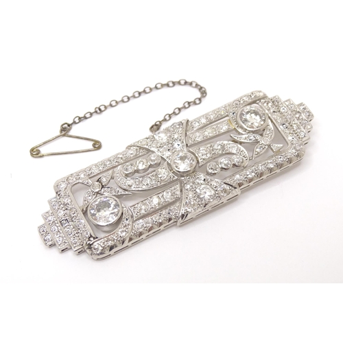 661 - An impressive Art Deco white metal brooch set with a profusion of diamonds. The two largest diamonds... 