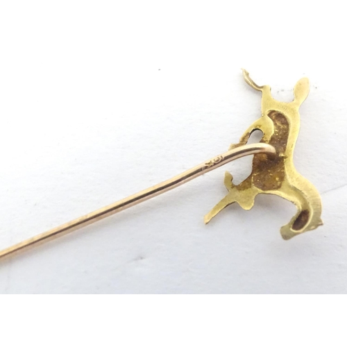 670 - A gold and yellow metal stick pin surmounted by a horse. Marked 10k. Approx 2 3/4