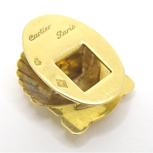 716 - A French gold stud / button of shell form by Cartier Paris. Marked verso and signed Cartier Paris.  ... 