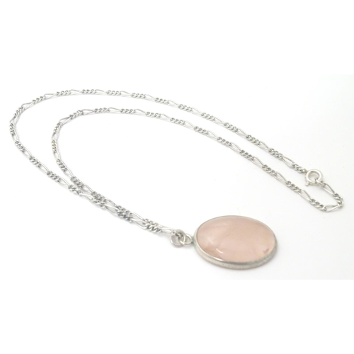 748 - A silver pendant set with rose quartz cabochon, Hallmarked London 1986 maker Tony Bestwick approx 1