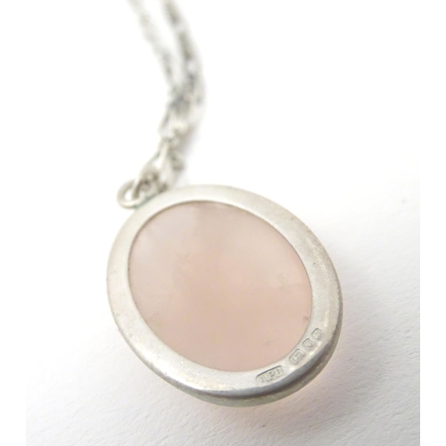 748 - A silver pendant set with rose quartz cabochon, Hallmarked London 1986 maker Tony Bestwick approx 1