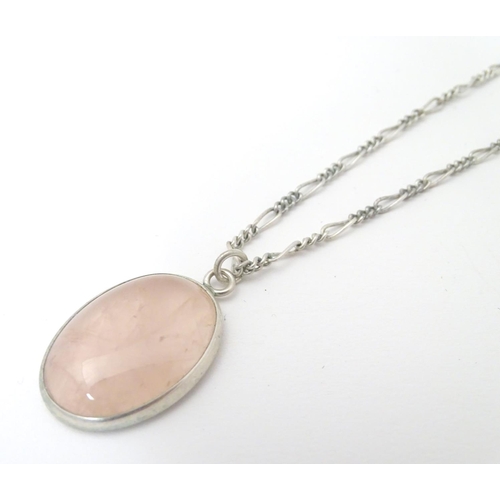 748 - A silver pendant set with rose quartz cabochon, Hallmarked London 1986 maker Tony Bestwick approx 1