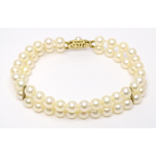 756 - A two strand pearl bracelet with 9ct gold clasp. Approx 7 1/2