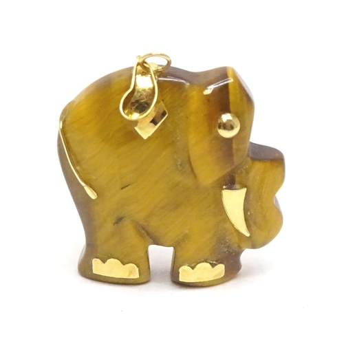 757 - A tigers eye pendant modelled as an elephant with 9ct gold mounts 1