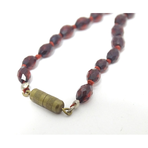 758 - A necklace of facet cut graduated cherry amber coloured bead. Approx 20