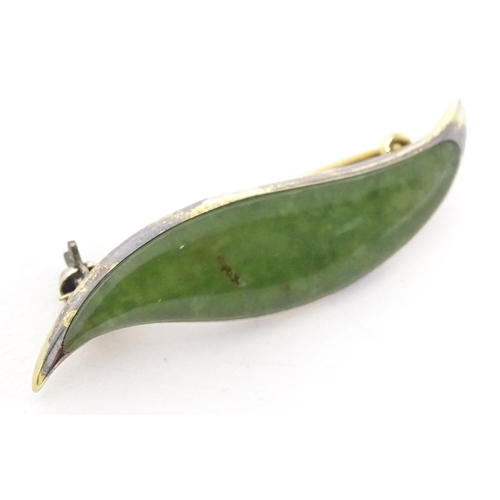 761 - A Sterling silver mounted New Zealand greenstone brooch formed as a leaf.
Approx. 1 1/2