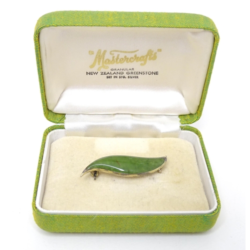 761 - A Sterling silver mounted New Zealand greenstone brooch formed as a leaf.
Approx. 1 1/2