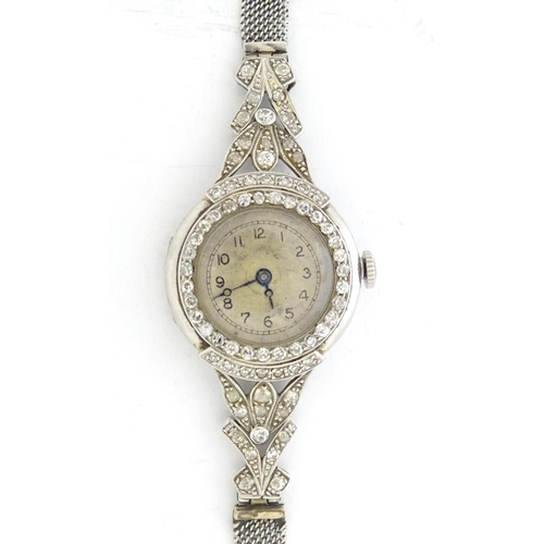 780 - A platinum and white metal ladies wrist watch set with a profusion of diamonds. The case approx. 3/4... 