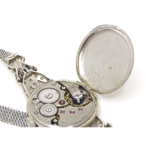 780 - A platinum and white metal ladies wrist watch set with a profusion of diamonds. The case approx. 3/4... 