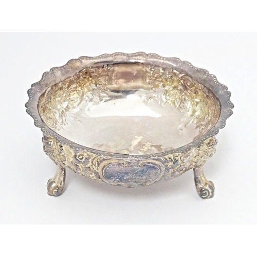 243 - A Victorian silver bowl with embossed decoration standing on three feet, hallmarked London 1878, mak... 