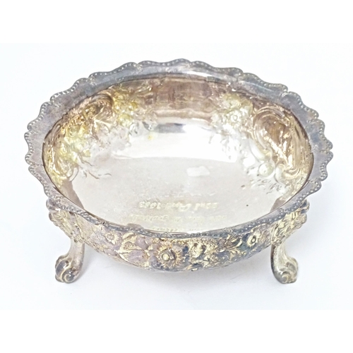 243 - A Victorian silver bowl with embossed decoration standing on three feet, hallmarked London 1878, mak... 