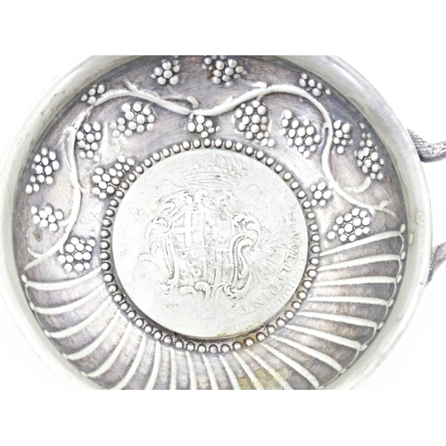 253 - A Continental silver wine taste / tete du vin / tastevin with Maltese style coin to base, bearing im... 