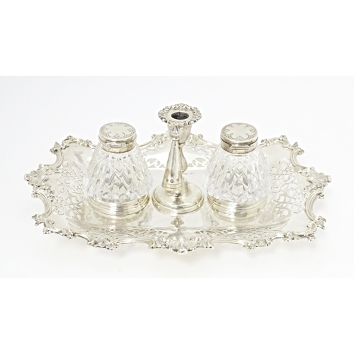 258 - A Victorian silver standish with central taper stick holder flanked by two cut glass ink bottles hal... 