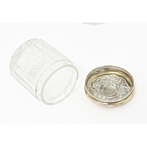 263 - Two glass dressing table / toilet jars with silver tops, one hallmarked Birmingham 1906, the other B... 