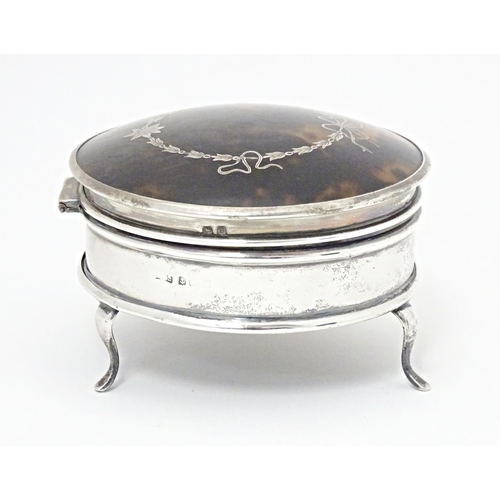 280 - A silver ring box of circular form with hinged lid having domed tortoiseshell and pique work decorat... 