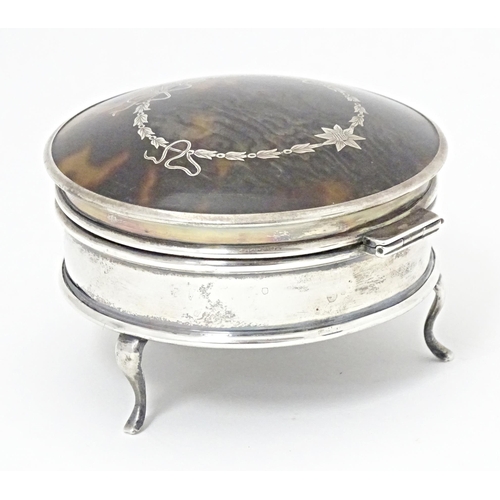 280 - A silver ring box of circular form with hinged lid having domed tortoiseshell and pique work decorat... 