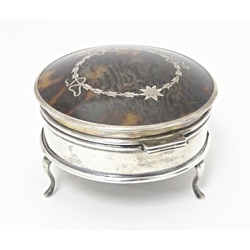 280 - A silver ring box of circular form with hinged lid having domed tortoiseshell and pique work decorat... 