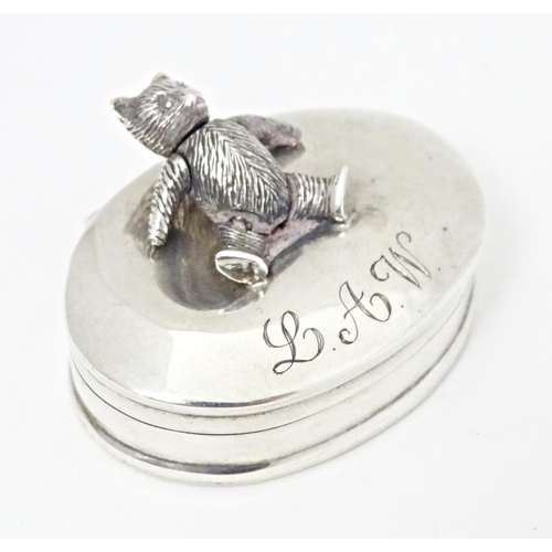 281 - A .925 silver pill box of oval form having articulated bear detail to lid. Approx. 1 1/2