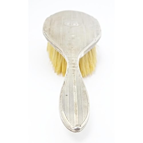 282 - An Art Deco silver backed brush and hand mirror with engine turned decoration, hallmarked Birmingham... 