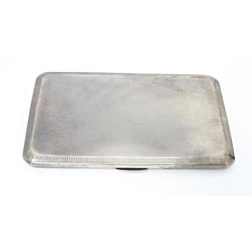 283 - An Art Deco silver cigarette case with engine turned decoration, hallmarked Birmingham 1937, maker A... 