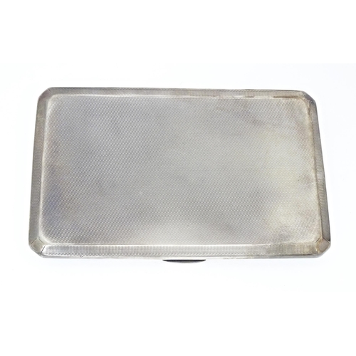 283 - An Art Deco silver cigarette case with engine turned decoration, hallmarked Birmingham 1937, maker A... 