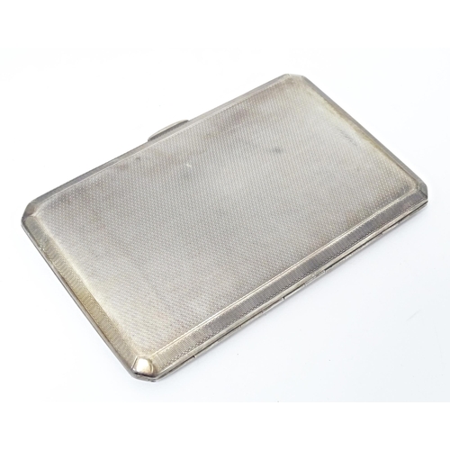 283 - An Art Deco silver cigarette case with engine turned decoration, hallmarked Birmingham 1937, maker A... 