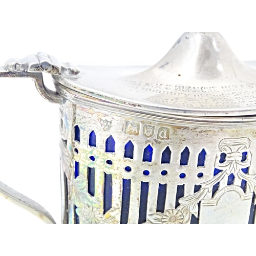 285 - A silver mustard pot with hinged lid, pierced detail and blue glass liner, hallmarked London1899, ma... 