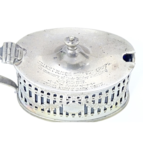 285 - A silver mustard pot with hinged lid, pierced detail and blue glass liner, hallmarked London1899, ma... 