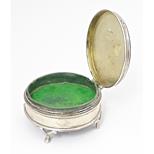 290 - A silver ring box of circular firm with out swept feet, hallmarked London 1917, maker Charles Edward... 