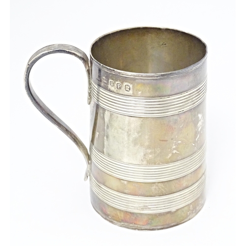 292 - A Geo III silver tankard with banded decoration and loop handle hallmarked London 1790, maker Henry ... 