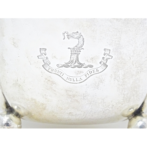 296 - A Scottish silver bowl of shaped form standing on three ball feet, with engraved armorial and motto,... 