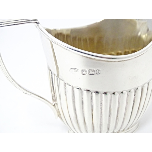 303 - A Victorian silver cream jug with fluted detail, hallmarked Sheffield 1894, maker John Round & Son L... 